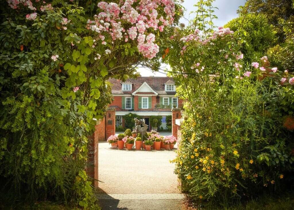 chewton glen entrance from car park with roses