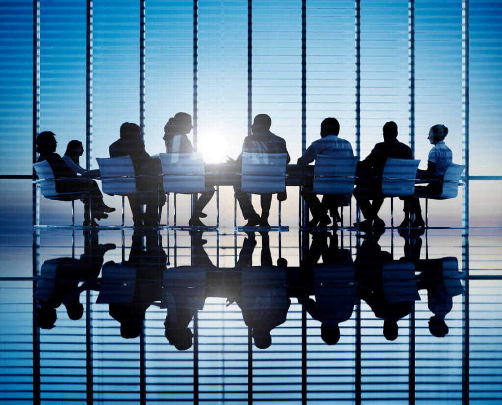 Silhouettes of business people in a conference room.
